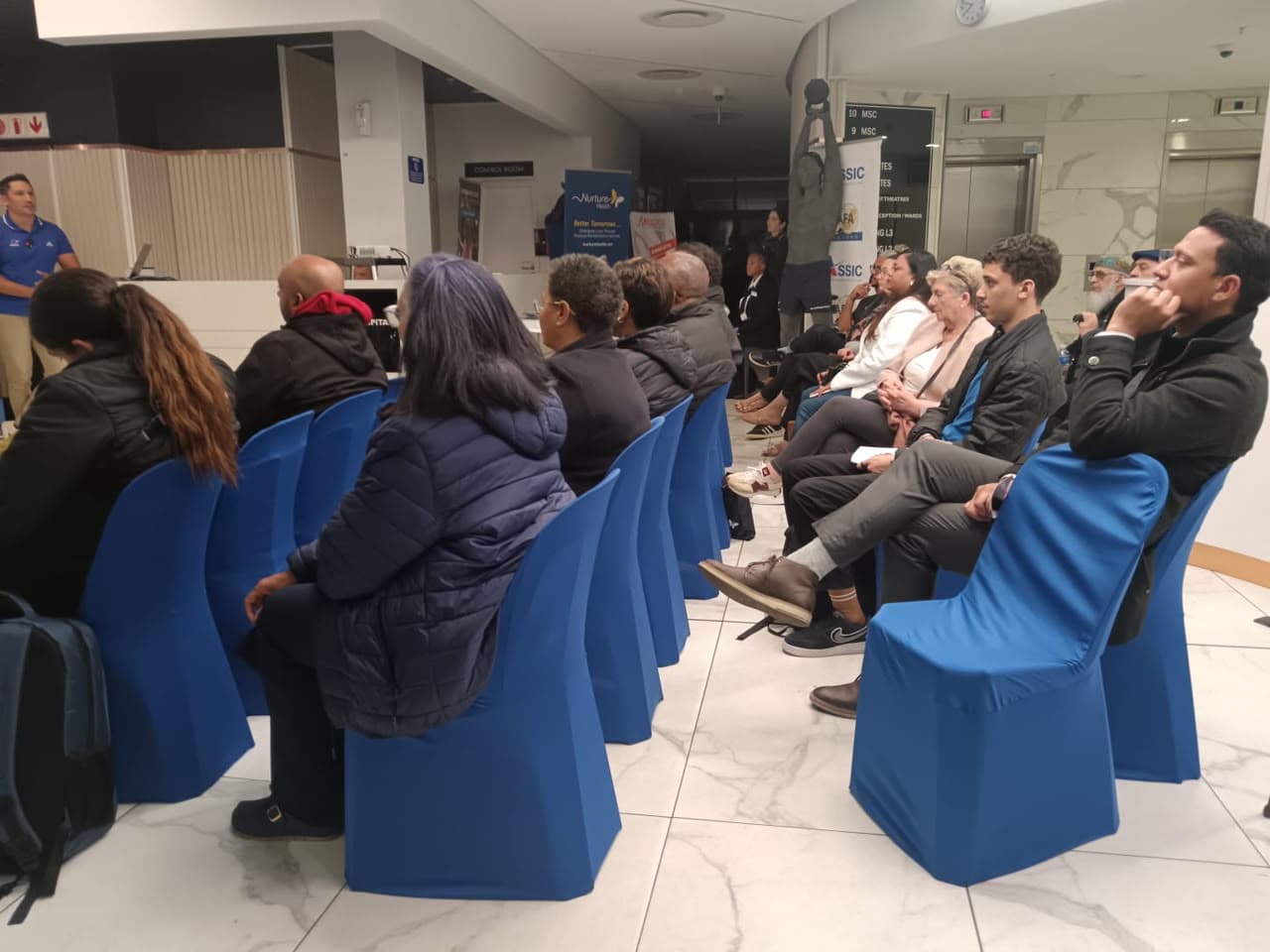 Audience seated on blue chairs during a sports medicine talk at a MedTalk Network event