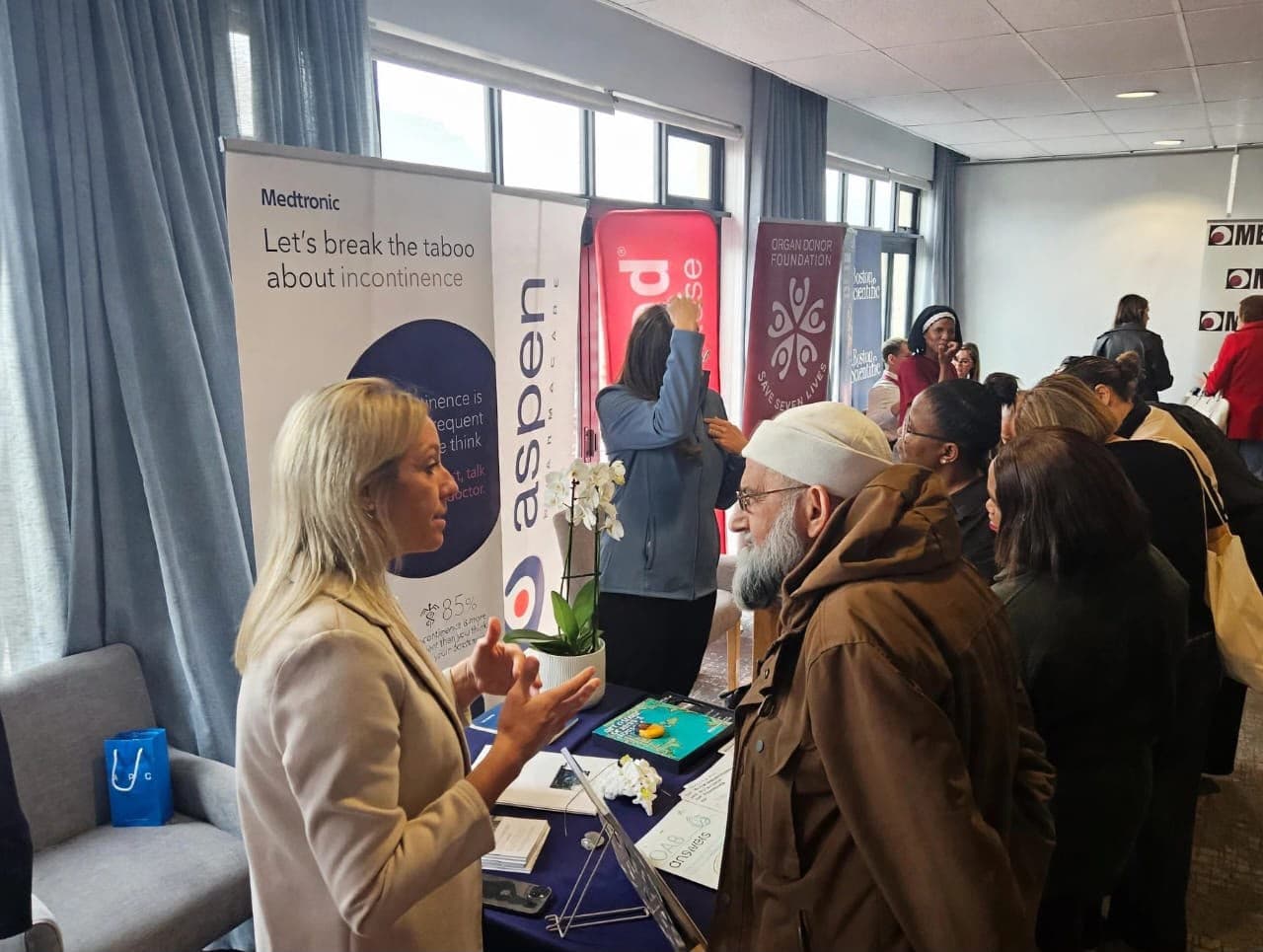Delegate talking with a representative at a partner exhibition stand at a MedTalk Network event