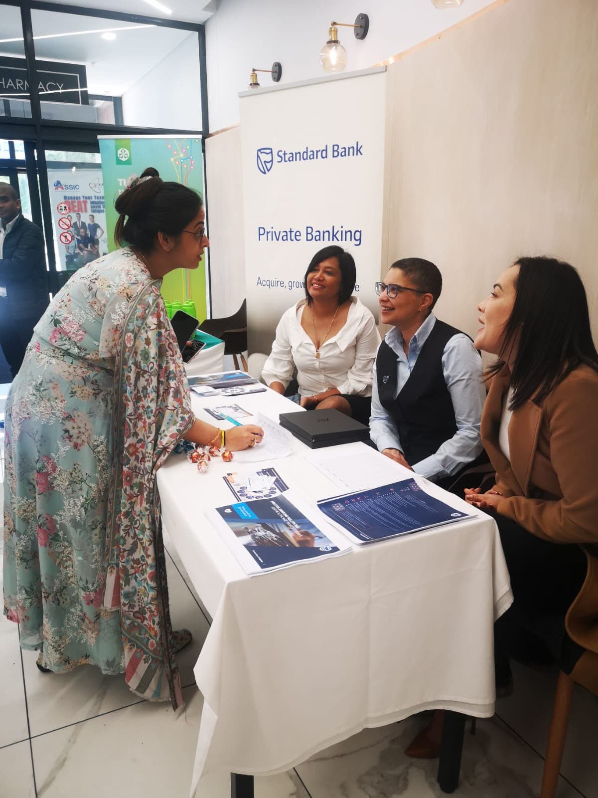 Delegate speaking with representatives at an exhibitor stand at a MedTalk Network event