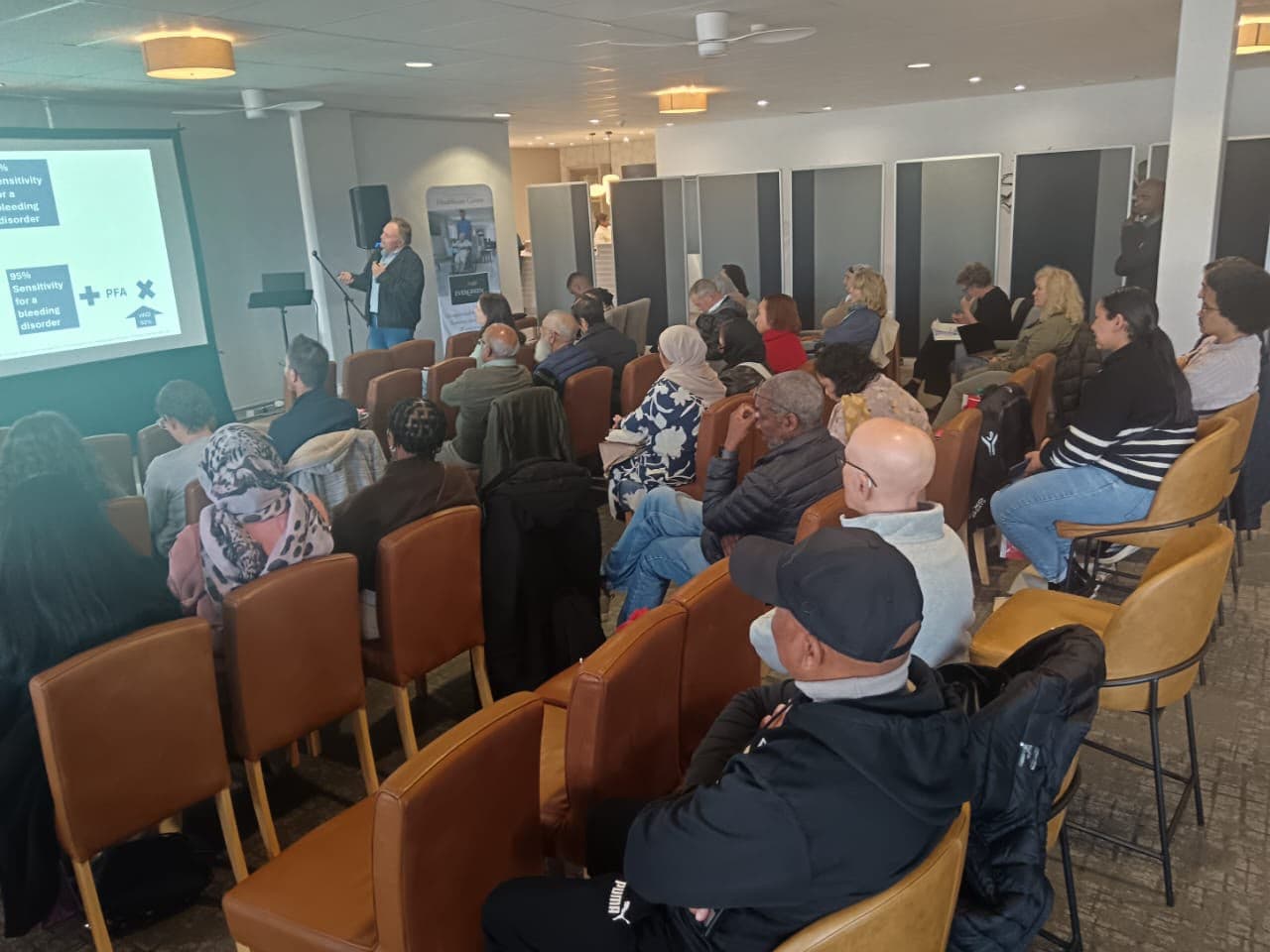 Speaker presenting on bleeding disorders to a room of healthcare professionals at a MedTalk Network event